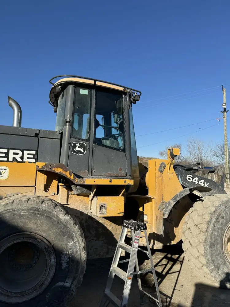 Wheel loader cab glass being replaced on-site at a jobsite in the SW Chicago suburbs