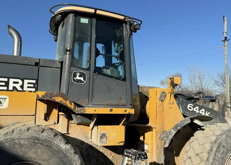 Wheel loader cab glass being replaced on-site at a jobsite in the SW Chicago suburbs