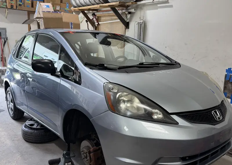 Mobile sedan windshield replacement in progress at a shop in the SW Chicago suburbs